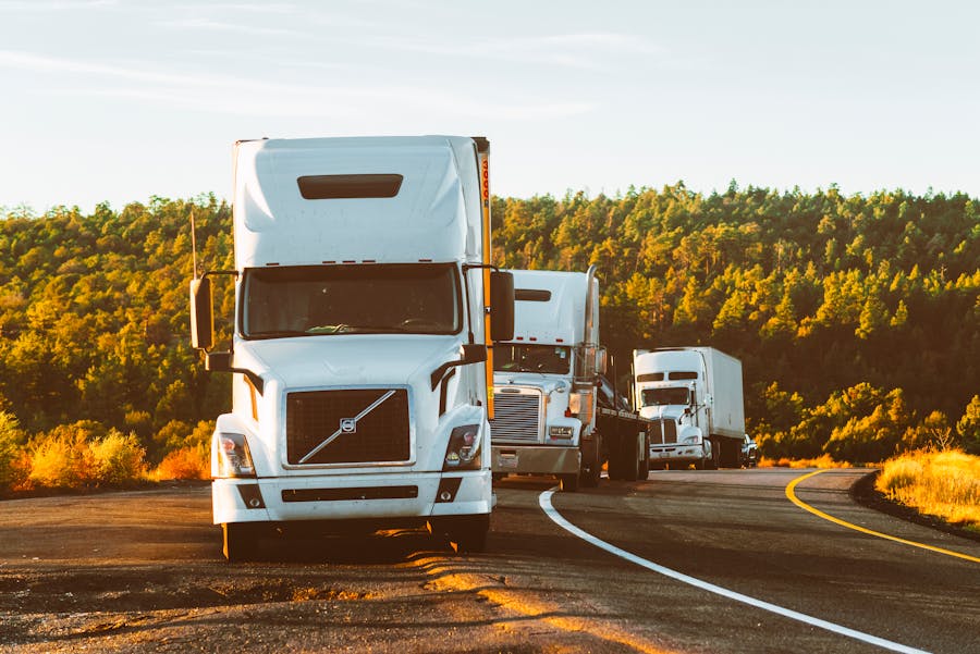 Convoy of long-haul semi trucks on a US interstate highway